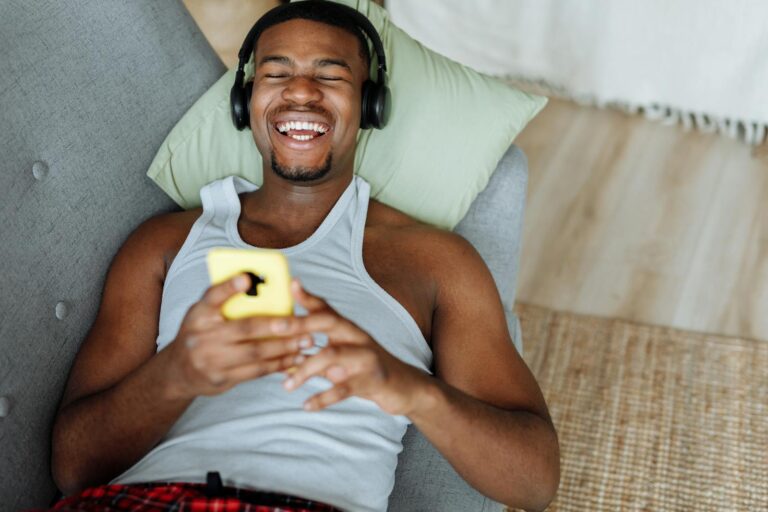 Culture Shock A Man in Tank Top Lying on the Couch with Headphones